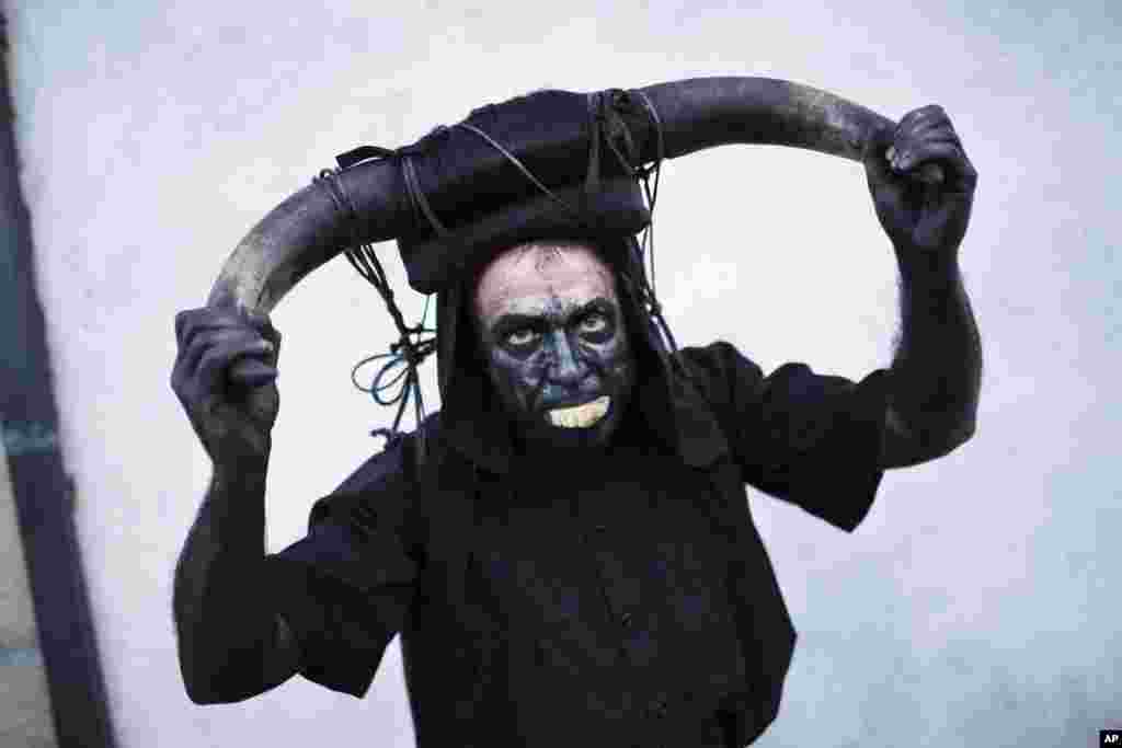 A man dressed as a devil parades with others during the Iberian mask festival in Viana do Bolo, north-west Spain, Jan. 13, 2018.