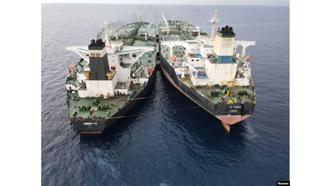 The Iranian-flagged Very Large Crude Carrier (VLCC), MT Arman 114, and the Cameroon-flagged MT S Tinos, are seen as they were spotted conducting a ship-to-ship oil transfer without a permit, according to Indonesia's Maritime Security Agency (Bakamla), near Indonesia's North Natuna Sea, Indonesia, July 7, 2023 in this handout picture released July 11, 2023.