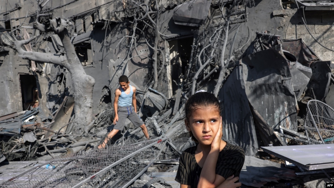 A girl looks on as she stands by the rubble outside a building that was hit by Israeli bombardment in Rafah in the southern Gaza Strip on Oct. 31, 2023.
