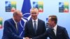Turkey's President Recep Tayyip Erdogan, left, shakes hands with Sweden's Prime Minister Ulf Kristersson, right, as NATO Secretary-General Jens Stoltenberg looks on prior to a meeting ahead of a NATO summit in Vilnius, Lithuania, July 10, 2023. 