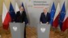 FILE - European Commissioner for Justice Didier Reynders, right, and Poland's new Justice Minister Adam Bodnar speak at a news conference at the Justice Ministry in Warsaw, Poland, Jan. 19, 2024.