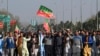 Supporters of Khan's Pakistan Tehreek-e-Insaf (PTI) party block Peshawar to Islamabad highway as they protest against the alleged skewing in Pakistan's national election results, in Peshawar on Feb. 11, 2024. 