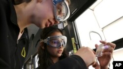 Students Siari Rodriguez, left, and Crystal Baker use a pH strip to test the pH of common substances in their Chemistry 121 class at Everett Community College, March 10, 2023.