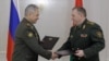 Russian Defense Minister Sergei Shoigu and his Belarusian counterpart Viktor Khrenin shake hands after signing an agreement on the relocation of some of Russia's tactical nuclear weapons to Belarus, in Minsk, May 25, 2023. (Russian Defense Ministry via AFP)