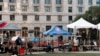 Media is stationed outside the Lewis R. Slaton Courthouse after a grand jury brought back indictments against former president Donald Trump, in Atlanta, Georgia, Aug. 15, 2023.