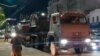 This video grab taken from footage posted June 24, 2023 shows a military vehicle of Wagner Group waiting for Prigozhin to leave the headquarters of the Russian southern military district in Rostov-on-Don as pedestrians film and salute him.