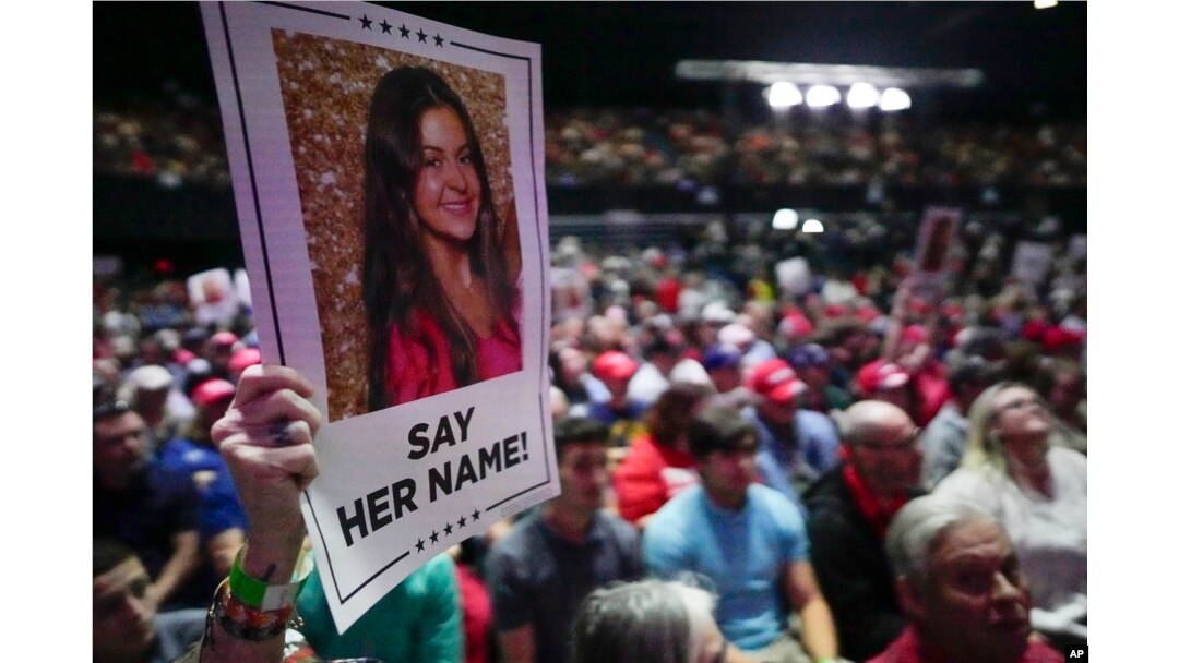 FILE - A supporter holds a poster with a photo of Laken Riley before Republican presidential candidate Donald Trump speaks at a campaign rally on March 9, 2024, in Rome, Georgia.