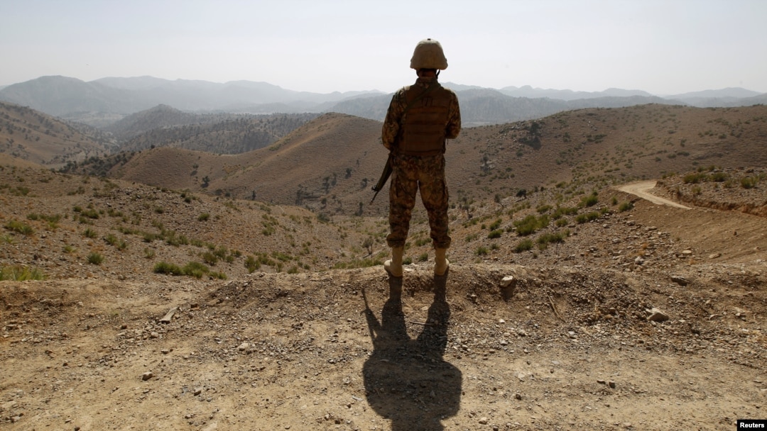 FILE - A soldier stands guard outside the Kitton outpost along the border fence on the border with Afghanistan in North Waziristan, Pakistan, on Oct. 18, 2017.