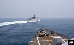 In this photo provided by the U.S. Navy, the USS Chung-Hoon observes a Chinese navy ship conduct what it called an "unsafe” Chinese maneuver in the Taiwan Strait, June 3, 2023. (Mass Communication Specialist 1st Class Andre T. Richard/U.S. Navy via AP)