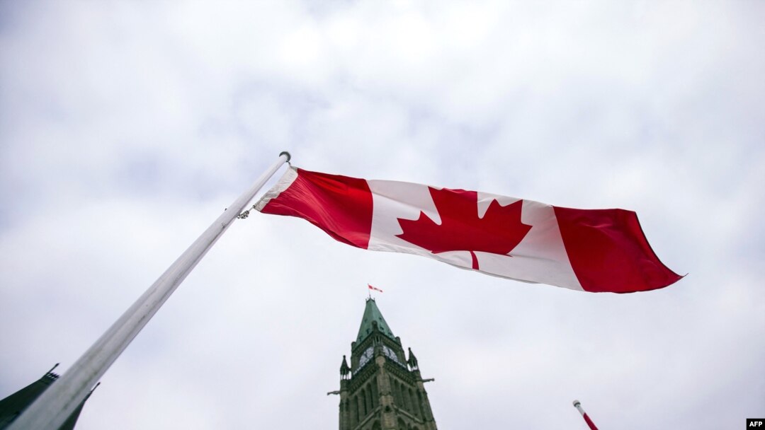 FILE - A Canadian flag flies in front of the peace tower on Parliament Hill in Ottawa, Canada on Dec. 4, 2015.