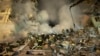 FILE - Emergency workers clear the rubble after a Russian rocket hit a building, leaving many people under debris in the southeastern city of Dnipro, Ukraine, Jan. 14, 2023.
