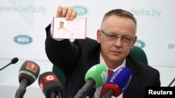Tomasz Szmydt, a Polish judge who requested political asylum in Belarus, shows his ID document during a press conference in Minsk, Belarus, May 6, 2024. (BelTA/Maxim Guchek/Handout via Reuters)