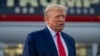 Former President Donald Trump speaks with reporters before departure from Hartsfield-Jackson Atlanta International Airport, Aug. 24, 2023, in Atlanta. 