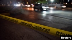 FILE - A police barricade tape is seen at a cordoned-off area where Ecuadorean prosecutor Cesar Suarez was killed, in Guayaquil, Ecuador, Jan. 17, 2024.