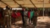 FILE - Burkina Faso servicemen carry a coffin during a funeral in Ouagadougou, Oct. 8, 2022, for 27 soldiers killed as they escorted a convoy in Gaskinde. The ambush, claimed by al-Qaida, has become a symbol of the state's inability to secure countryside areas.