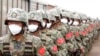 In this handout photo taken from video released by Russian Defense Ministry Press Service on Aug. 29, 2022, Chinese soldiers participate in war games drills, in Grodekovo, Primorsky Krai, Russia. 