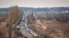 Cars wait to pick up family members and refugees fleeing the war in Ukraine, in Palanca, Moldova, March 2, 2022. 