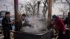 Ukrainian volunteers prepare food for displaced people outside Lviv railway station, in Lviv, western Ukraine, March 3, 2022.