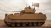 FILE - American soldiers drive a Bradley Fighting Vehicle during a joint exercise with Syrian Democratic Forces in northeastern Syria, Dec. 8, 2021. The U.S. will be sending Bradleys to aid Ukraine in its battle against Russian invaders.