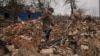 Mariya, a local resident, looks for personal items in the rubble of her house, destroyed during fighting between Russian and Ukrainian forces in the village of Yasnohorodka, on the outskirts of Kyiv, Ukraine, March 30, 2022.