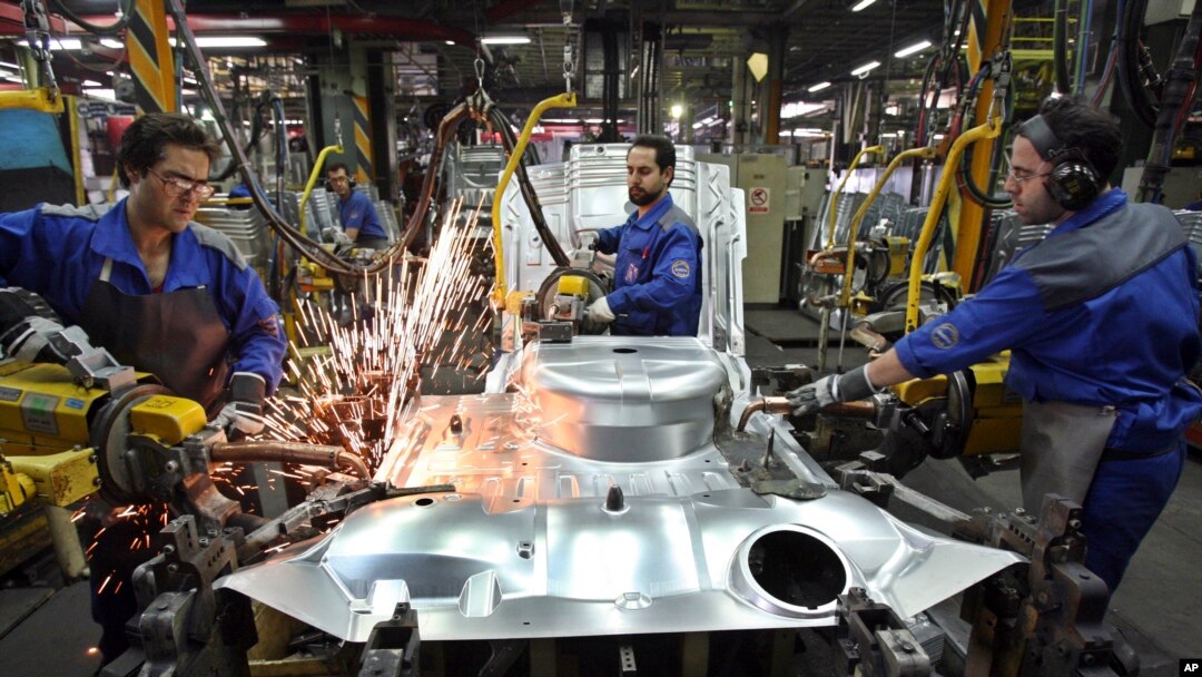 FILE - Iranian car workers weld parts of a car body, at the state-run Iran Khodro automobile manufacturing plant, which they claim is the largest car maker in the Middle East, near Tehran, Iran, April 20, 2011.