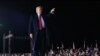 US President Donald Trump gestures after speaking during a rally in support of Republican incumbent senators Kelly Loeffler and David Perdue in Dalton, Georgia, on January 4, 2021.