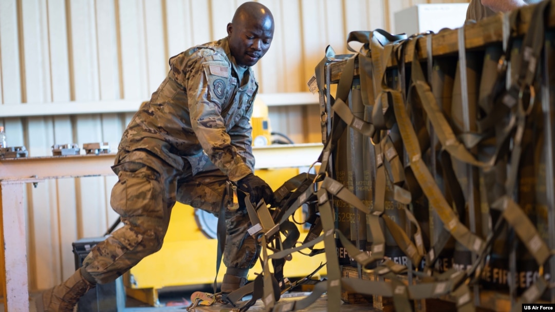 FILE - A US Air Force senior airman secures a pallet with munitions at Travis Air Force Base, California, April 28, 2022.