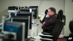 FILE - A worker sits a computer at the Department of Homeland Security's National Cybersecurity and Communications Integration Center (NCCIC) in Arlington, Va., Aug. 22, 2018. 