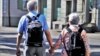 FILE - A couple walks while holding hands in this undated stock photo. A child born in the U.S. in 2021 is expected to live 76.4 years, the lowest figure since 1996, according to data from the U.S. Centers for Disease Control and Prevention.