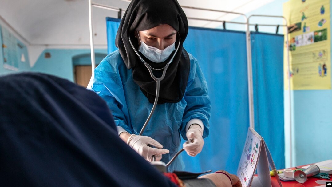 FILE - A Save the Children midwife provides Zarmina, 25, who is five months pregnant, with a pre-natal check-up in Jawzjan province in northern Afghanistan, Sunday, Oct. 2, 2022. (Save the Children via AP, File)