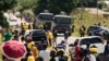FILE - Zimbabwe police patrol outside the venue where Nelson Chamisa of the Citizens Coalition for Change was to speak in Marondera, March 12, 2022. In September, journalist Ruvimbo Muchenje was barred entry to a CCC event; another reporter was also barred and harassed. 