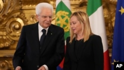 Italian President Sergio Mattarella gestures while talking with newly-appointed Italian Premier Giorgia Meloni during her swearing-in ceremony at Quirinal presidential palace in Rome, Oct. 22, 2022.