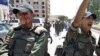 An injured Syrian army soldier (L) walks with his comrades after a roadside bomb hit their military truck, Daraa city, southern Syria, May 9, 2012. 