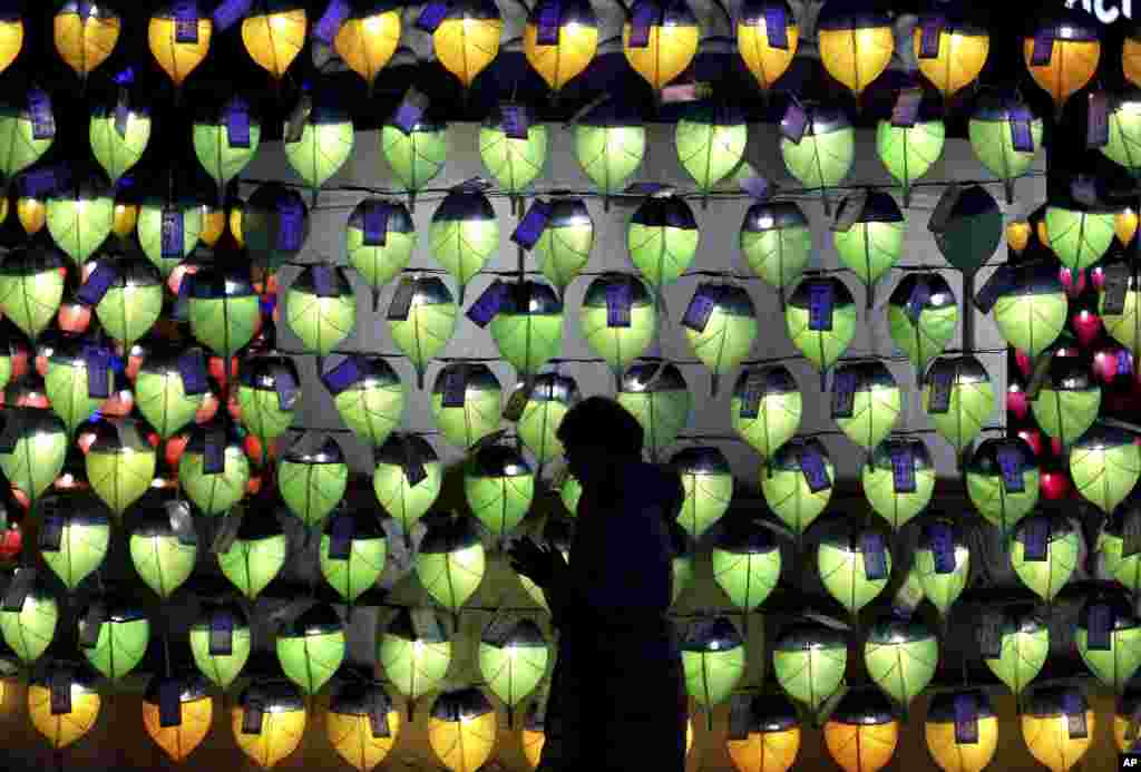 A woman prays in front of lanterns to celebrate the New Year at Jogyesa Buddhist temple in Seoul, South Korea.