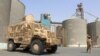 FILE - Soldiers with a military coalition in Yemen backed by Saudi Arabia and the United Arab Emirates stand guard at a facility of Yemen's Red Sea Mills company in the port city of Hodeida, Jan. 22, 2019.