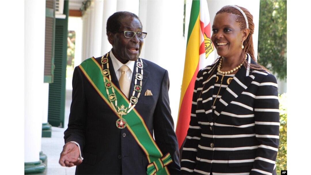 FILE - Zimbabwe President Robert Mugabe stands with his wife Grace, as they pose for a photo at State House in Harare.