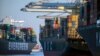 FILE - A container ship, left, moves past the Georgia Ports Authority's Port of Savannah, Sept. 29, 2021, in Savannah, Ga. The World Trade Organization is predicting a slowdown in the growth of global trade flows in 2023.