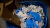 FILE - a view of a waste basket with syringes and gloves after residents received a dose of the third Pfizer COVID-19 vaccine, at San Jeronimo nursing home, in Estella, northern Spain, Sept. 23. 2021. 