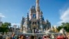 FILE - Performers dressed as Mickey Mouse, Minnie Mouse, Goofy, Donald Duck and Daisy Duck entertain visitors at Cinderella Castle at Walt Disney World Resort in Lake Buena Vista, Florida, on April 18, 2022.