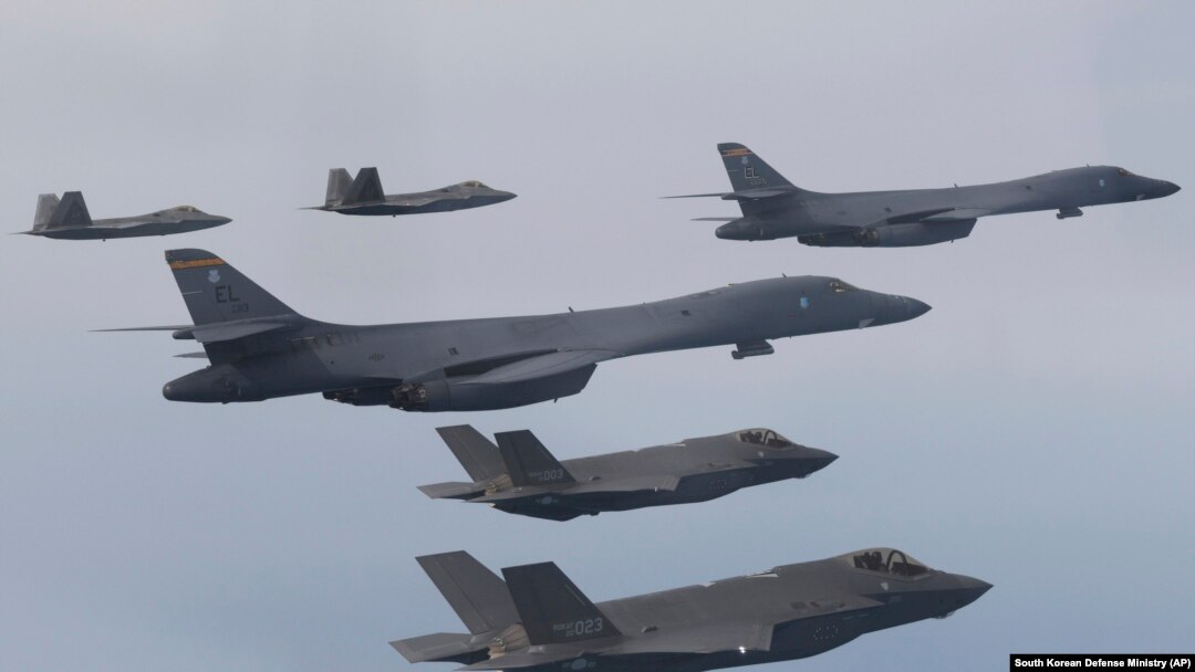 FILE - In this photo provided by South Korean Defense Ministry, U.S. Air Force B-1B bombers, center, F-22 fighter jets and South Korean Air Force F-35 fighter jets, bottom, fly during a joint air drill in South Korea, Jan. 1, 2023. 