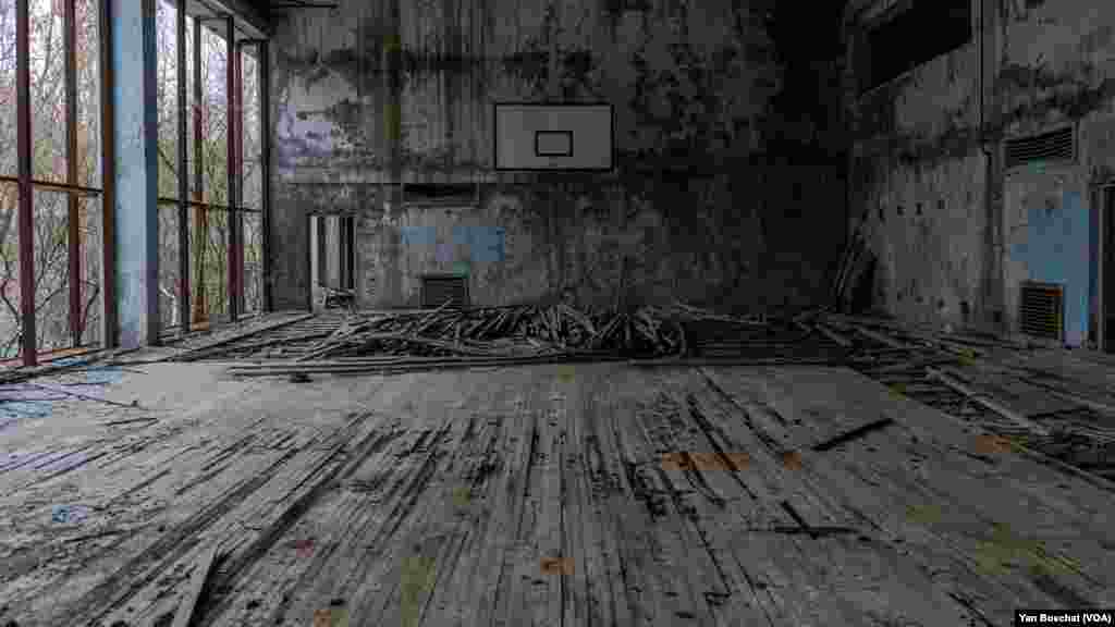 A basketball court inside one of the buildings abandoned in Prypiat. Russian soldiers took over the place after invading Ukraine and stayed for almost two months there. In Chernobyl, in Ukraine, Jan. 31, 2023 (VOANEWS/Yan Boechat)