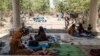 FILE - People rest at the entrance of the Agda Hotel, in the city of Semera, Afar region, Ethiopia, Feb. 14, 2022. 