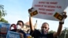 FILE - Muslim men hold placards as they take part in a demonstration demanding more rights for ethnic and religious minorities, outside Independence Square in Colombo, Sri Lanka, March 5, 2022.