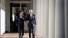 U.S. President Joe Biden and French President Emmanuel Macron walk down the Colonnade to the Oval Office at the White House, Dec. 1, 2022.