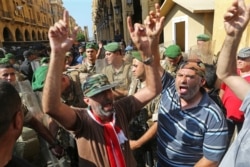 Veterans shout slogans during a protest against cuts to their benefits in the state budget, at downtown Beirut, Lebanon, July 19, 2019.