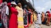 Des femmes devant un magasin de vêtements dans une rue du quartier populaire d'Adjame à Abidjan, en Côte d'Ivoire, le 1er mars 2022. 