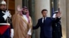 French President Emmanuel Macron and Saudi Crown Prince Mohammed bin Salman gesture ahead of a working dinner at the Elysee Palace in Paris, France, July 28, 2022. 