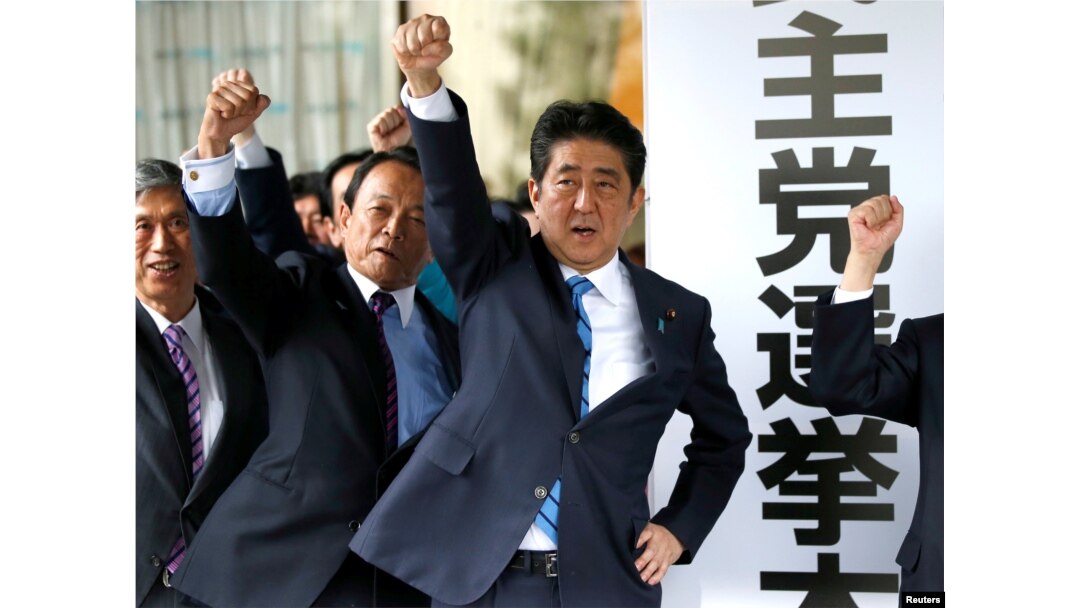 Japan's Prime Minister Shinzo Abe (3rd L) and his party's lawmakers raise their fists as they pledge to win in the upcoming lower house election, at their party headquarters in Tokyo, Japan September 28, 2017.