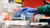 FILE - A researcher at Protein Sciences works in a lab in Meriden, Connecticut, March 12, 2020, when the biotech company was researching a vaccine for COVID-19.