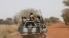 FILE - Soldiers from Burkina Faso patrol on the road of Gorgadji in the Sahel area, Burkina Faso, March 3, 2019.